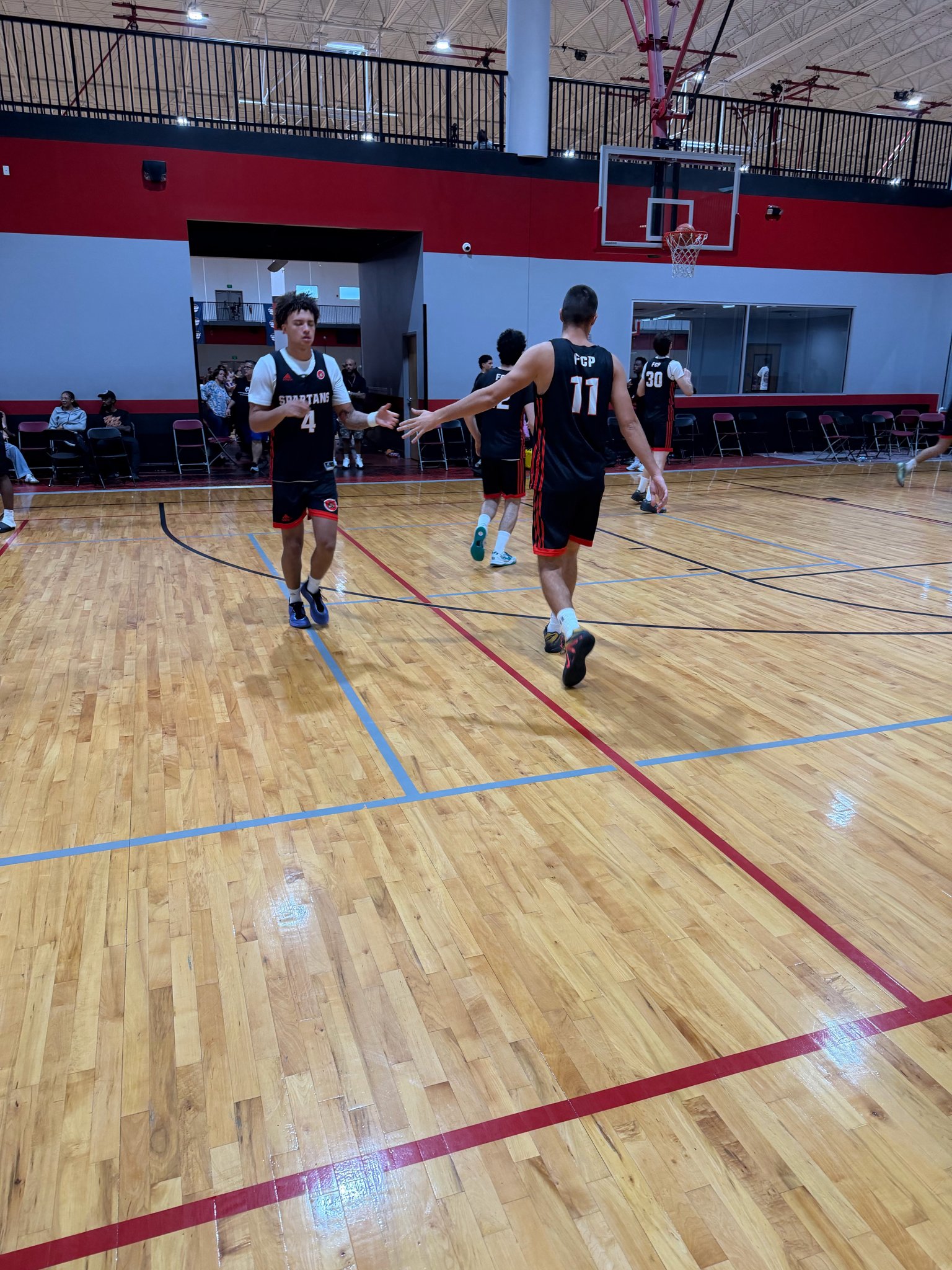 FCP Spartans players slapping hands at the All-American Jamboree in Orlando