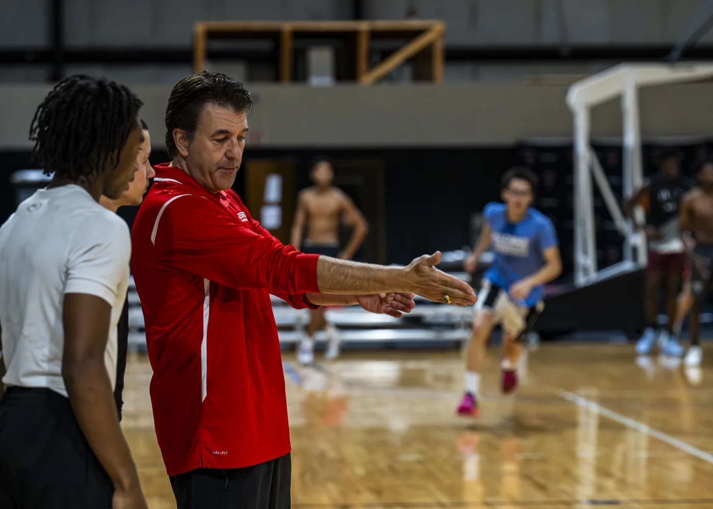 Florida Coastal Prep coach working with athletes on the basketball court