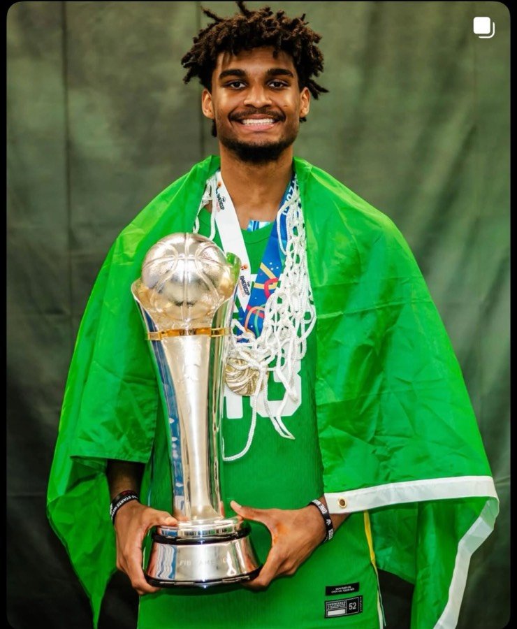 Nathan Mariano celebrating the FIBA AmeriCup 2025 championship with the trophy and Brazilian flag